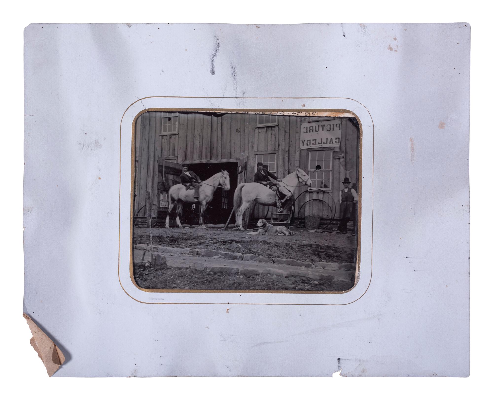 [EARLY PHOTOGRAPHY]. Half plate tintype of men, horses, & a dog outside of a "Picture Gallery."