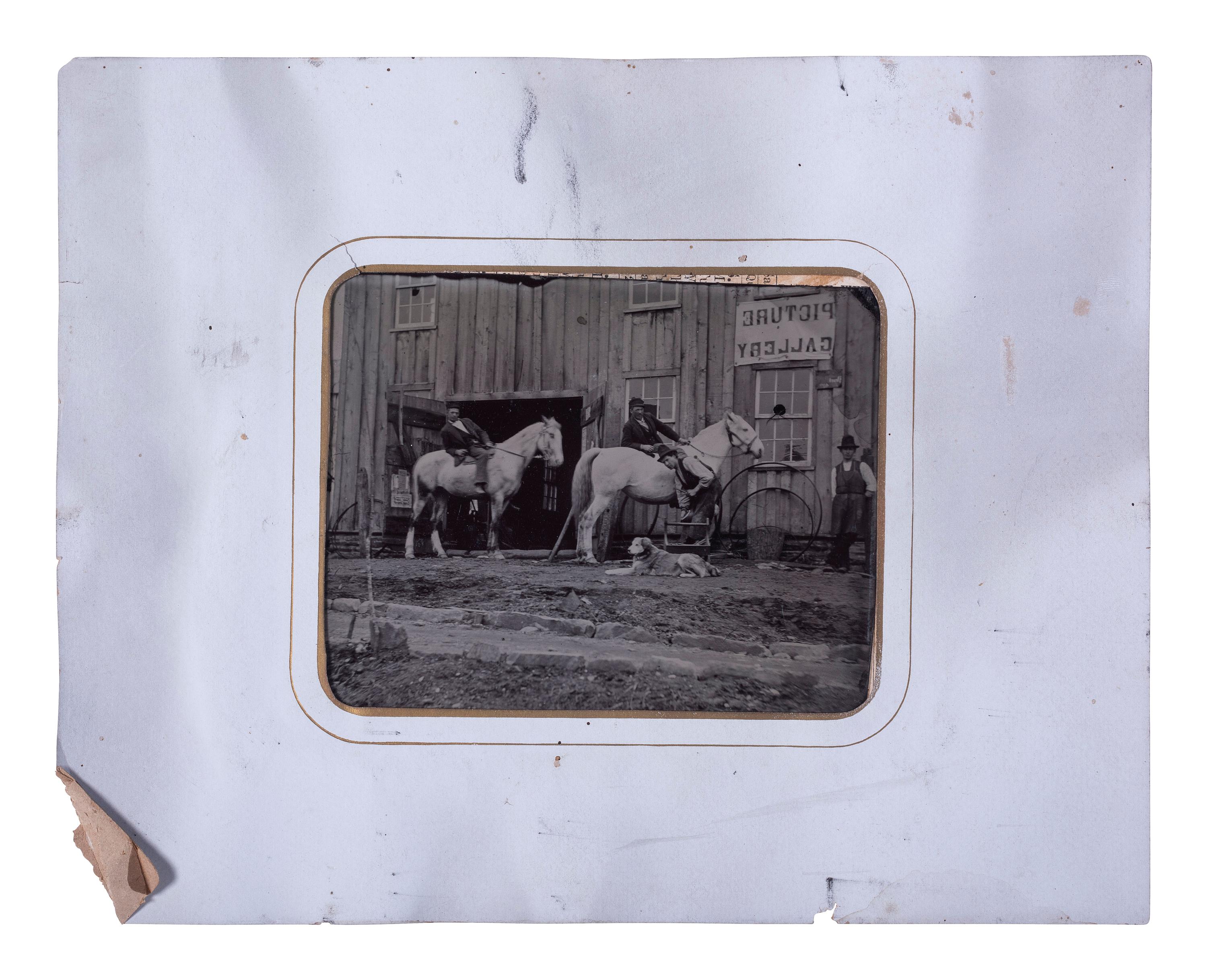 [EARLY PHOTOGRAPHY]. Half plate tintype of men, horses, & a dog outside of a "Picture Gallery."