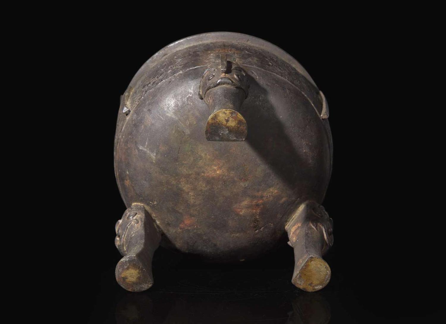 A large Chinese patinated bronze archaistic tripod censer, Ding, and wood cover, The Bronze 17th/18th Century or Earlier 清 青銅鼎式爐