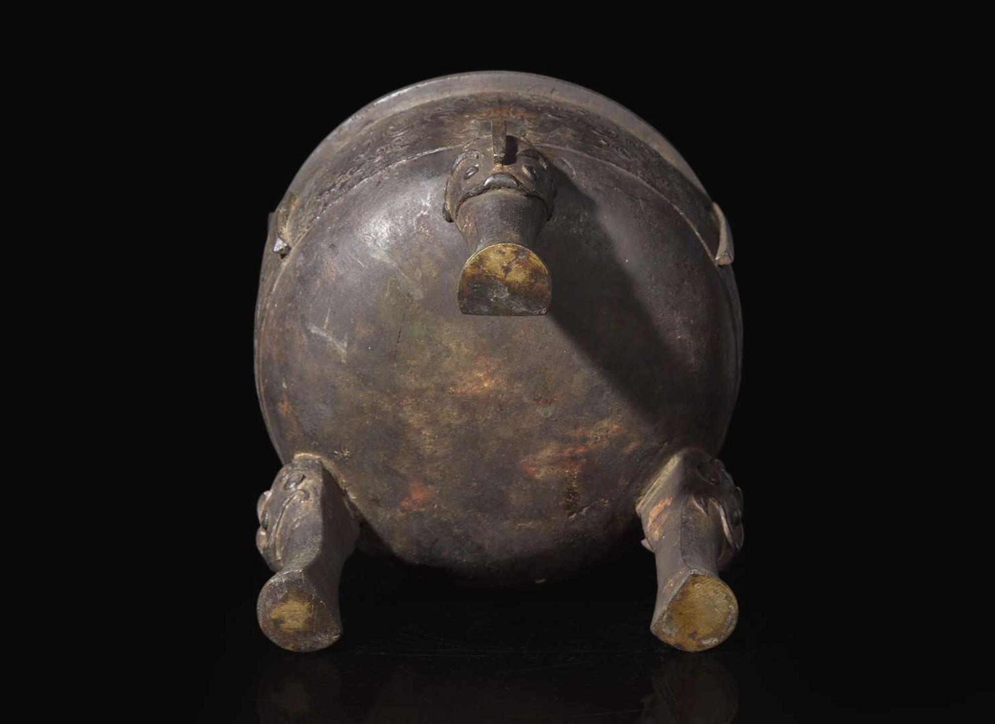 A large Chinese patinated bronze archaistic tripod censer, Ding, and wood cover, The Bronze 17th/18th Century or Earlier 清 青銅鼎式爐