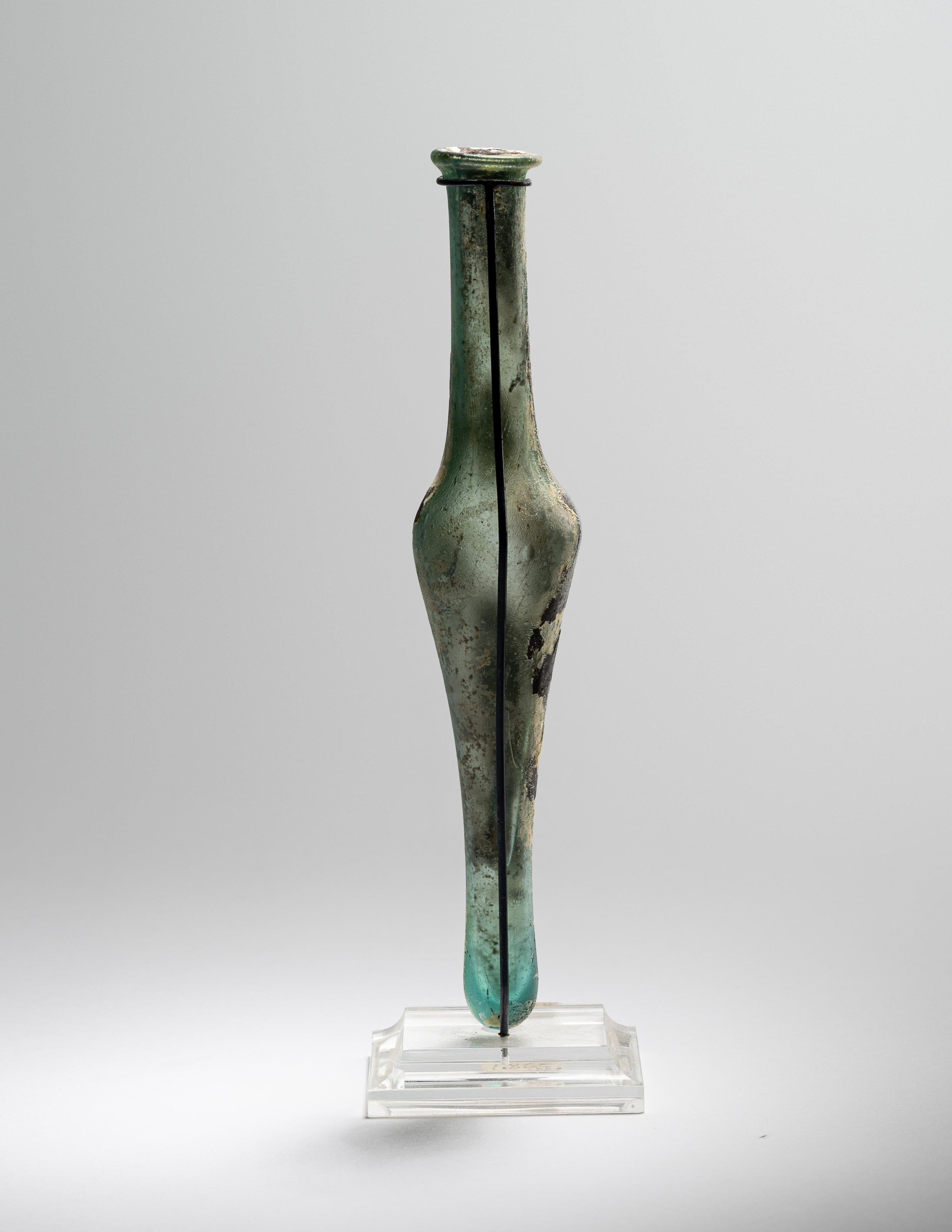 A Roman Pale Blue Glass Unguentarium