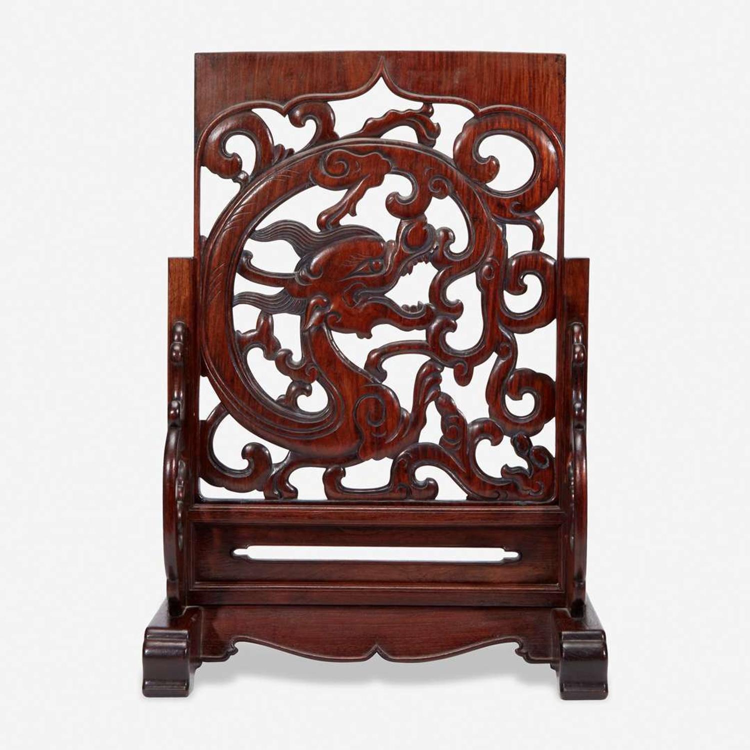 A Chinese carved and pierced huanghuali "dragon" panel, in later hardwood stand 黄花梨镂雕龙纹木板 后配底座 The panel late Ming/Qing dynasty ??????
