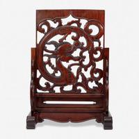 A Chinese carved and pierced huanghuali "dragon" panel, in later hardwood stand 黄花梨镂雕龙纹木板 后配底座 The panel late Ming/Qing dynasty ??????