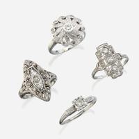 A collection of four white gold and diamond rings