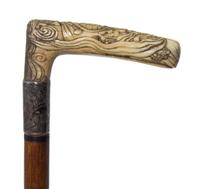 A Japanese Bone Handled Cane, Length of handle 4 1/2 x length overall 31 1/8 inches.