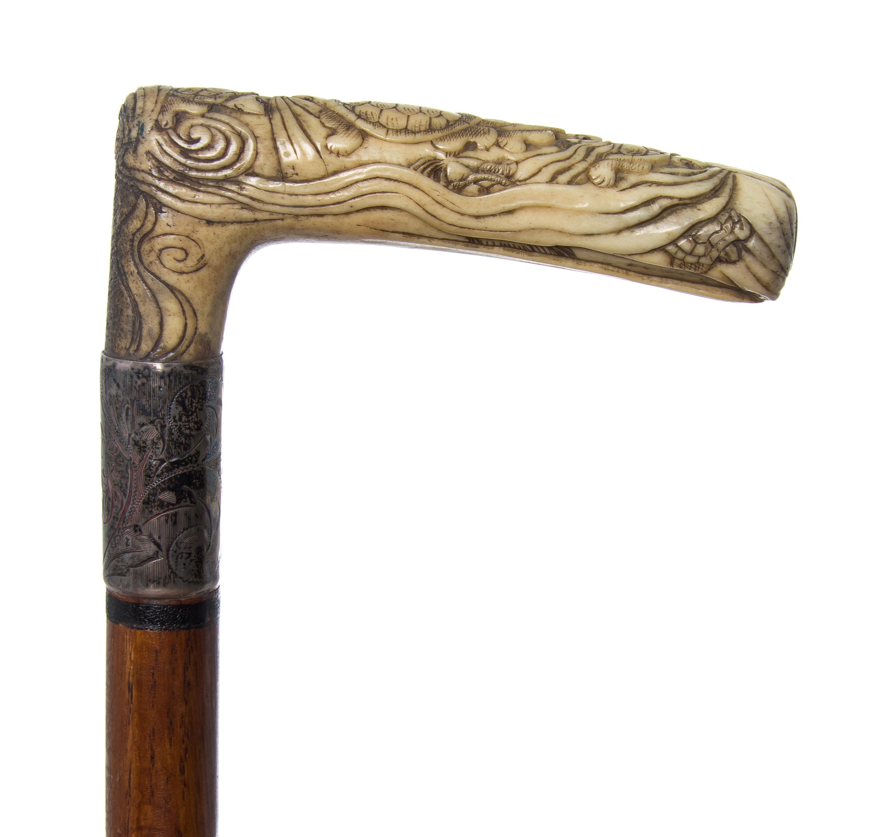 A Japanese Bone Handled Cane, Length of handle 4 1/2 x length overall 31 1/8 inches.