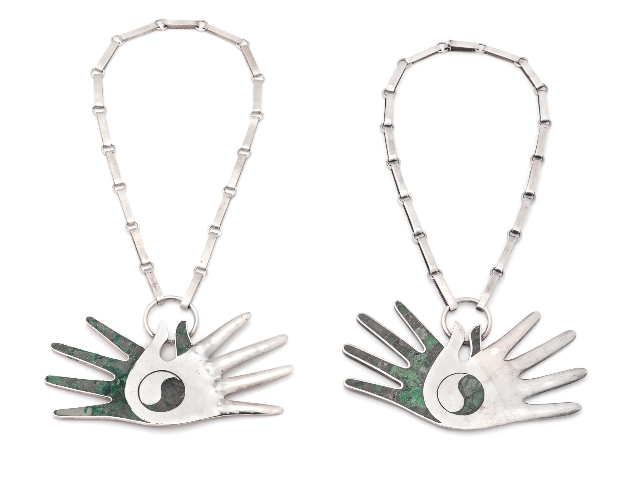 A Pair Sterling Silver and Turquoise Crossed Hands Necklaces, 116.00 dwts.