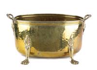 An English Hammered Brass Footed Jardiniere Height 9 1/2 x width 19 1/2 x depth 11 1/2 inches. — 20TH CENTURY