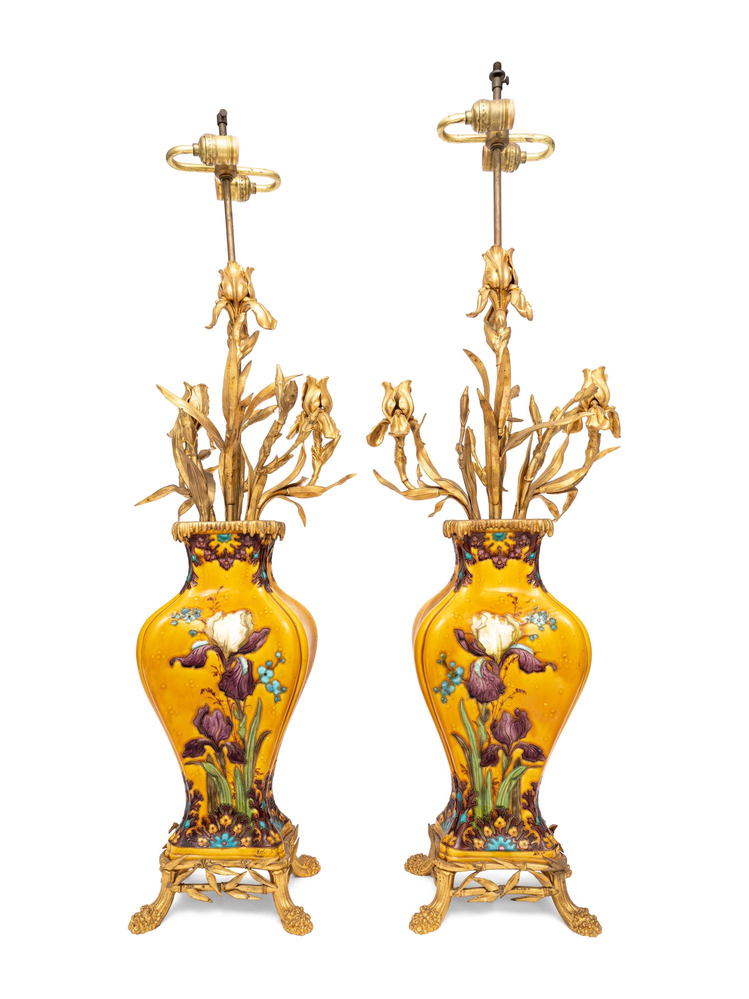 A Pair of Continental Gilt Metal Mounted Polychrome Glazed Porcelain Lamps