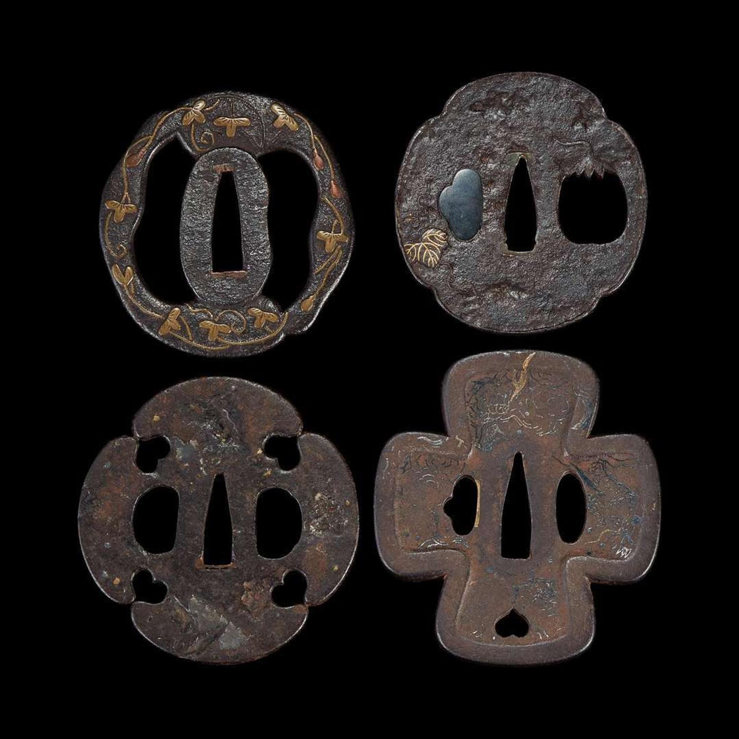 Group of eight Japanese inlaid iron tsuba Edo period or earlier