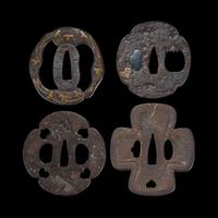 Group of eight Japanese inlaid iron tsuba Edo period or earlier
