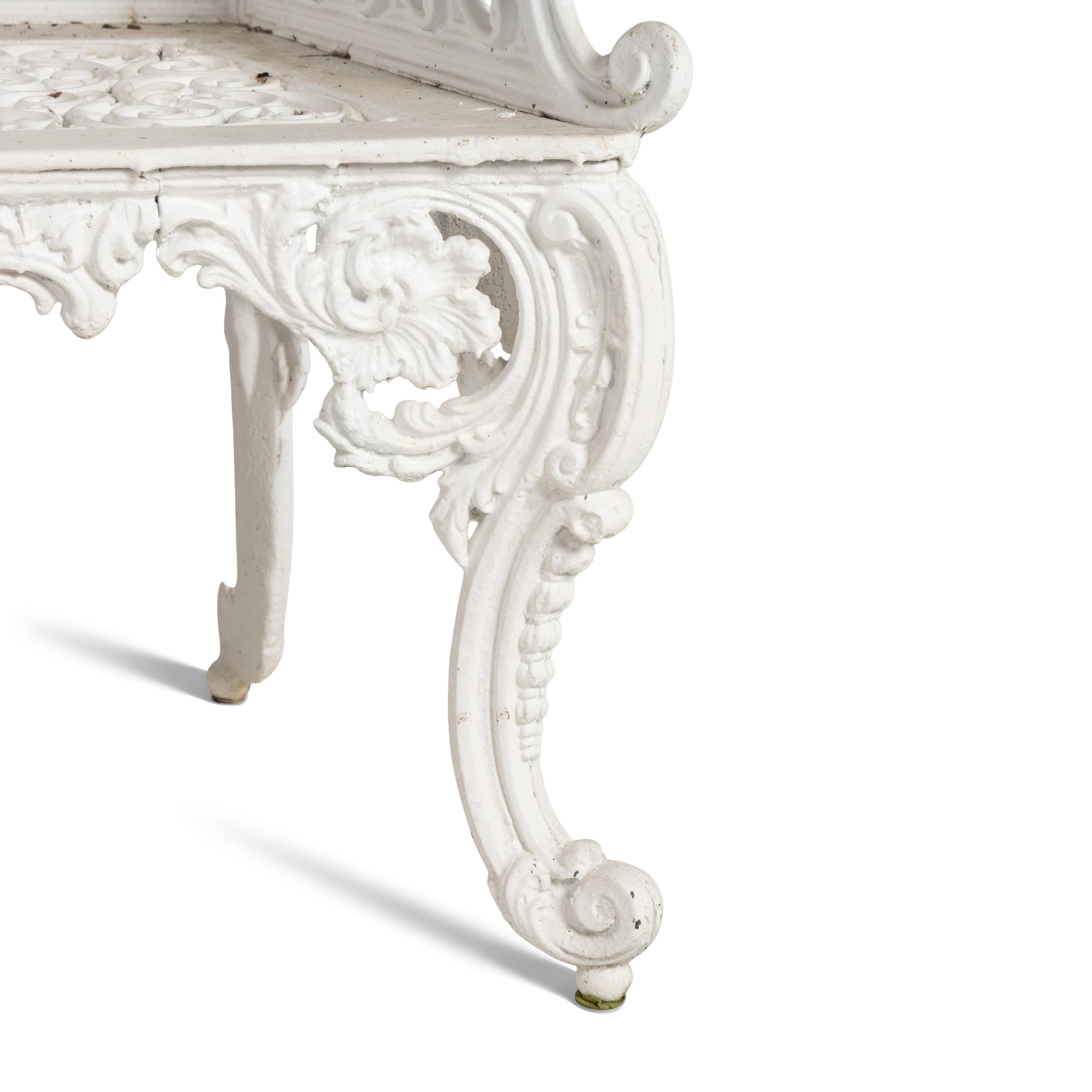A White-Painted Cast Iron Three-Piece Garden Seating Suite