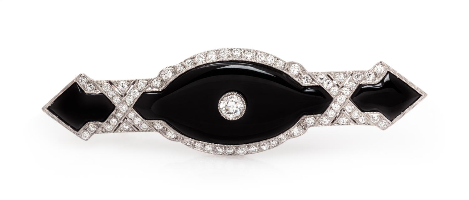 An Art Deco Platinum, Onyx and Diamond Bar Brooch, 6.40 dwts.