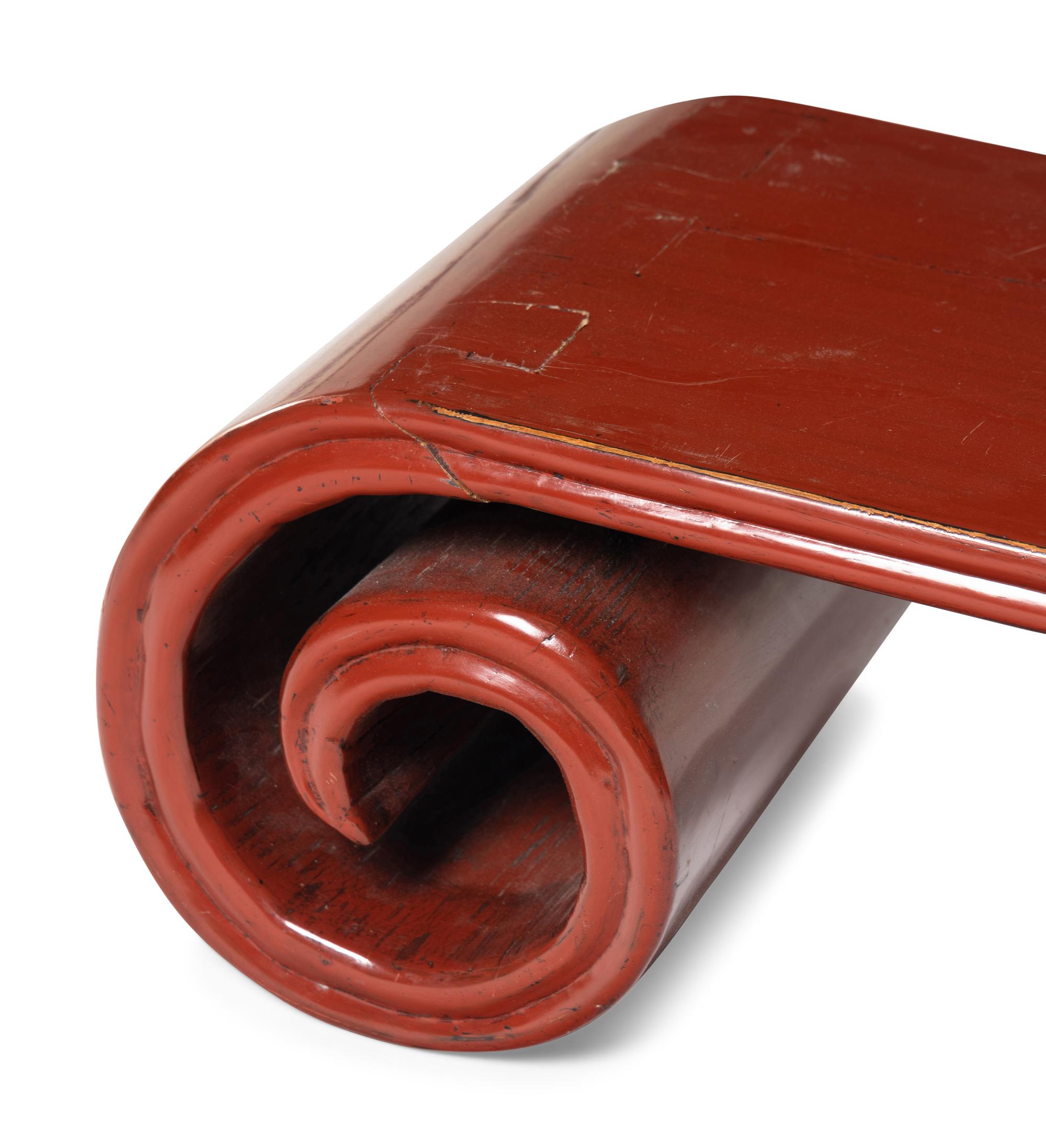 A Chinese Red Lacquered Low Scrolled-Form Low Table, Qinzhuo