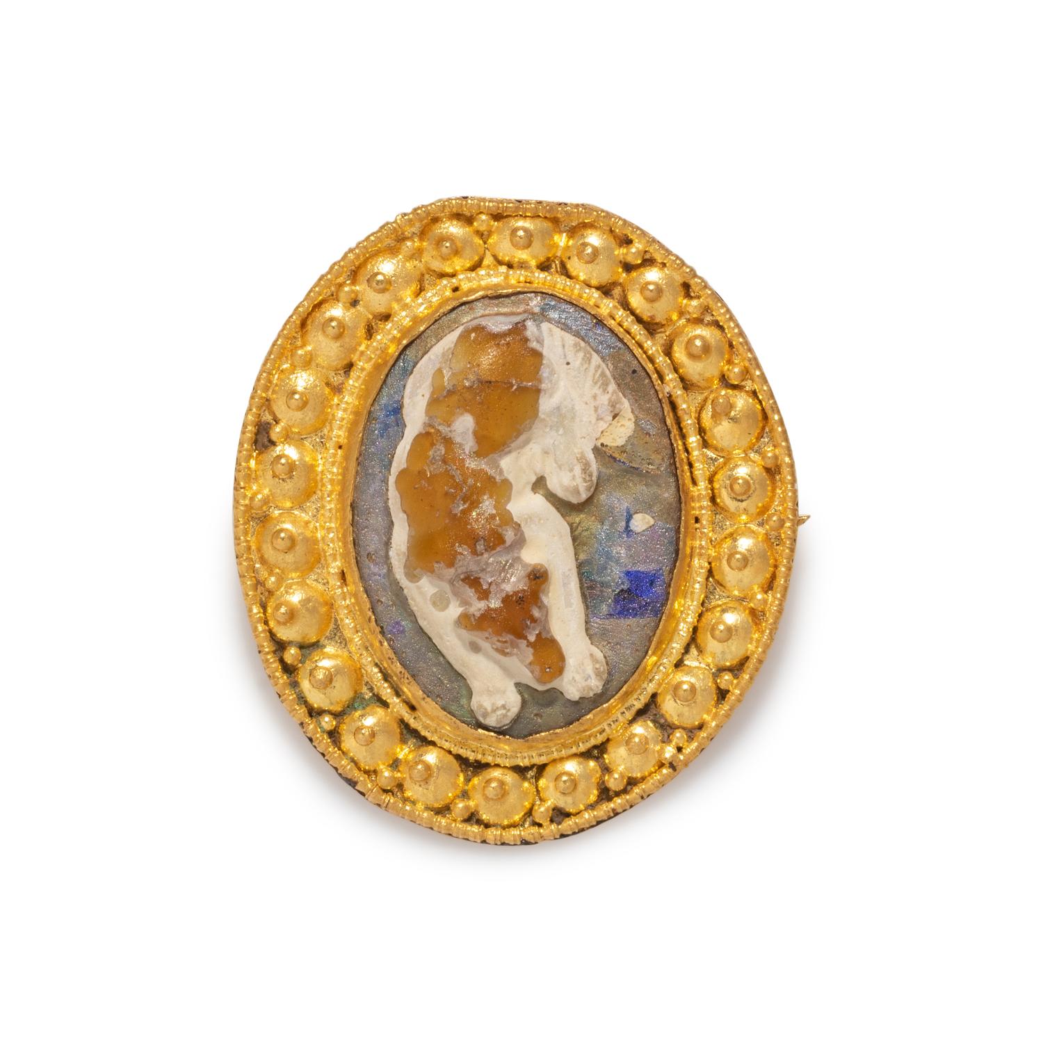 A Roman Gold and Glass Cameo Brooch with a Sleeping Dog