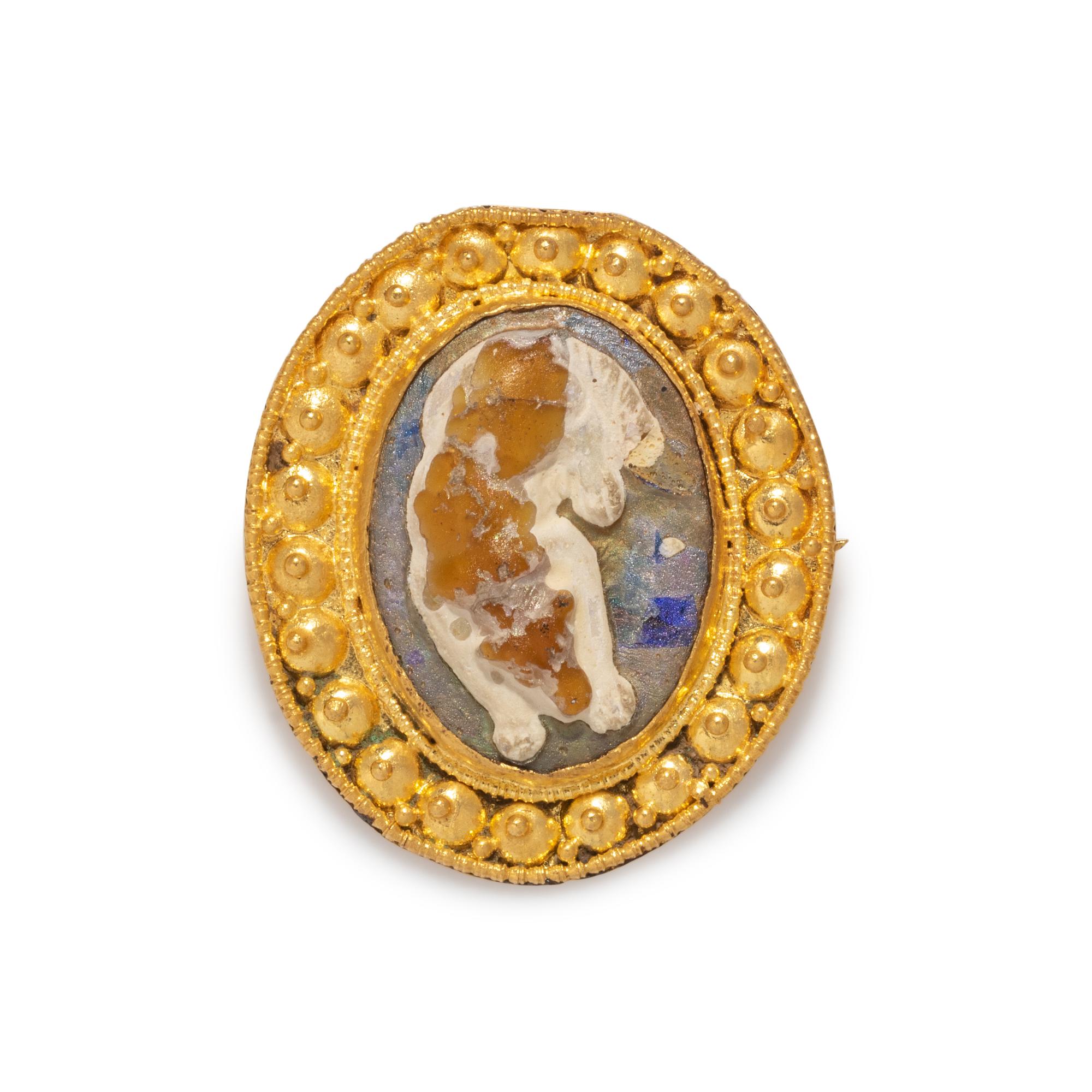 A Roman Gold and Glass Cameo Brooch with a Sleeping Dog