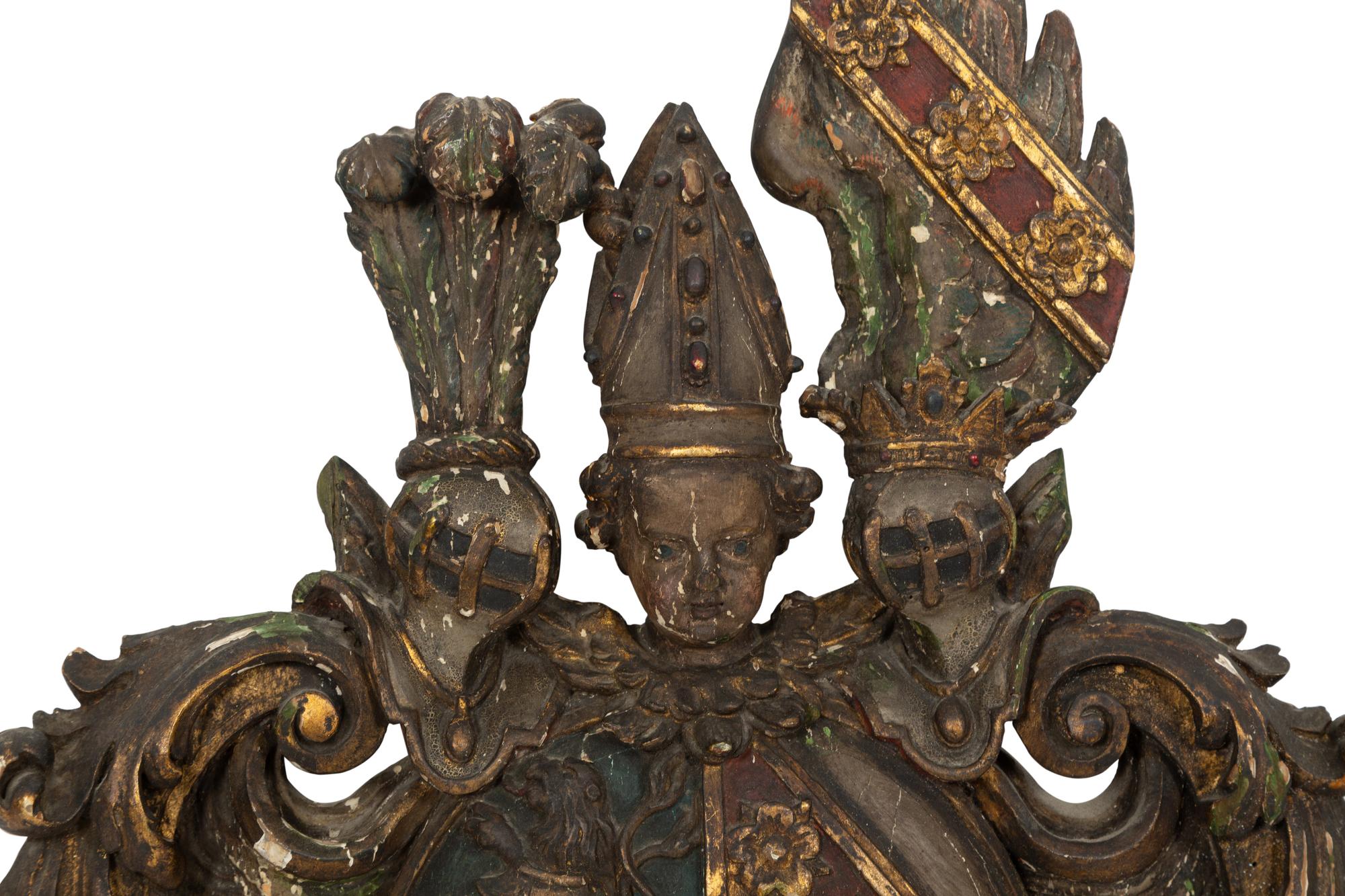 An Italian Painted and Parcel Gilt Carved Armorial Plaque