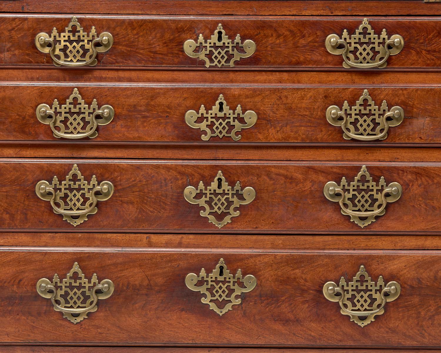 A Chippendale Figured and Carved Walnut Desk-and-Bookcase