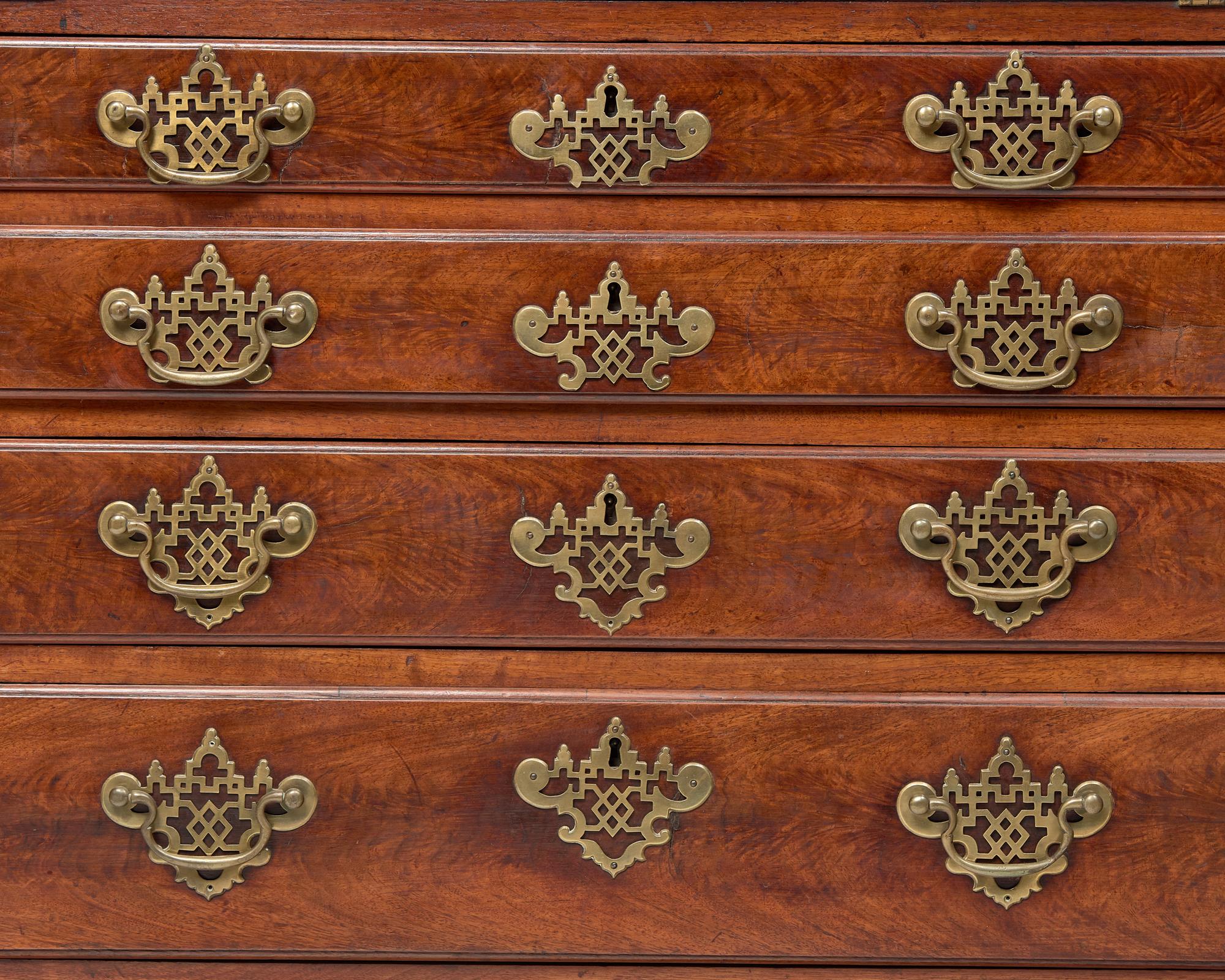 A Chippendale Figured and Carved Walnut Desk-and-Bookcase