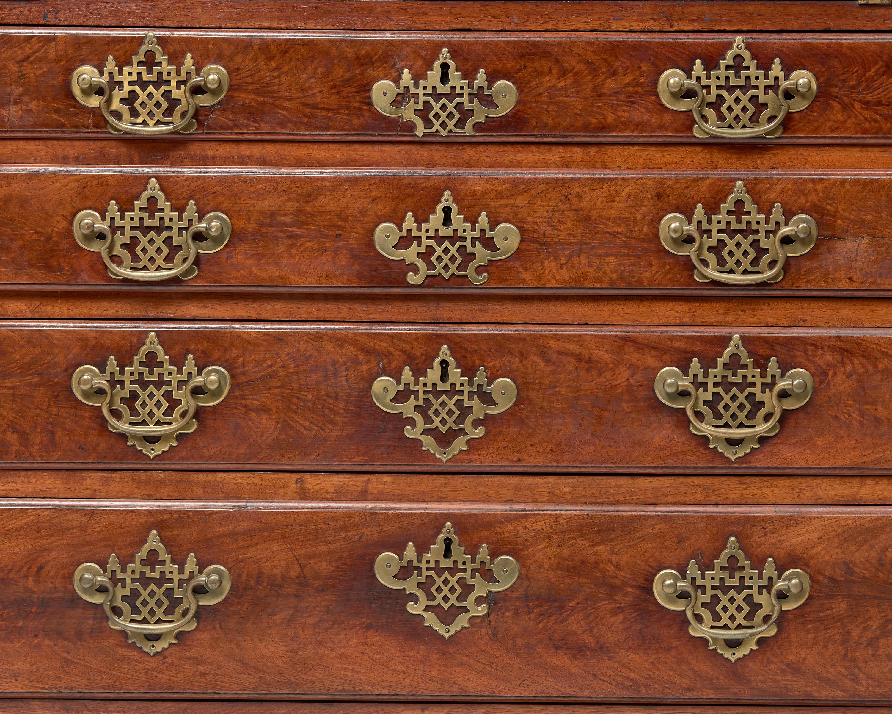 A Chippendale Figured and Carved Walnut Desk-and-Bookcase