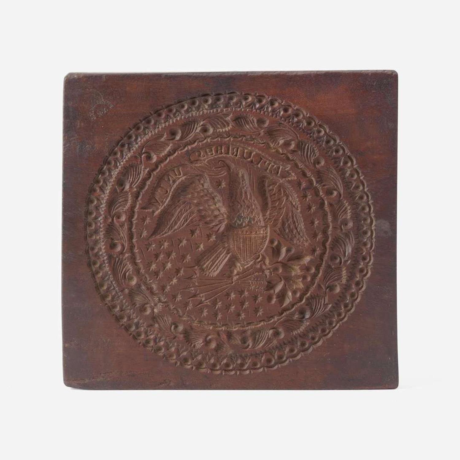A carved mahogany cake board Stamped J. Conger and J.Y. Watkins, New York