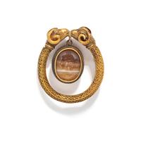 A Roman Banded Agate Intaglio with the God Apollo — Set in a gold brooch with rams