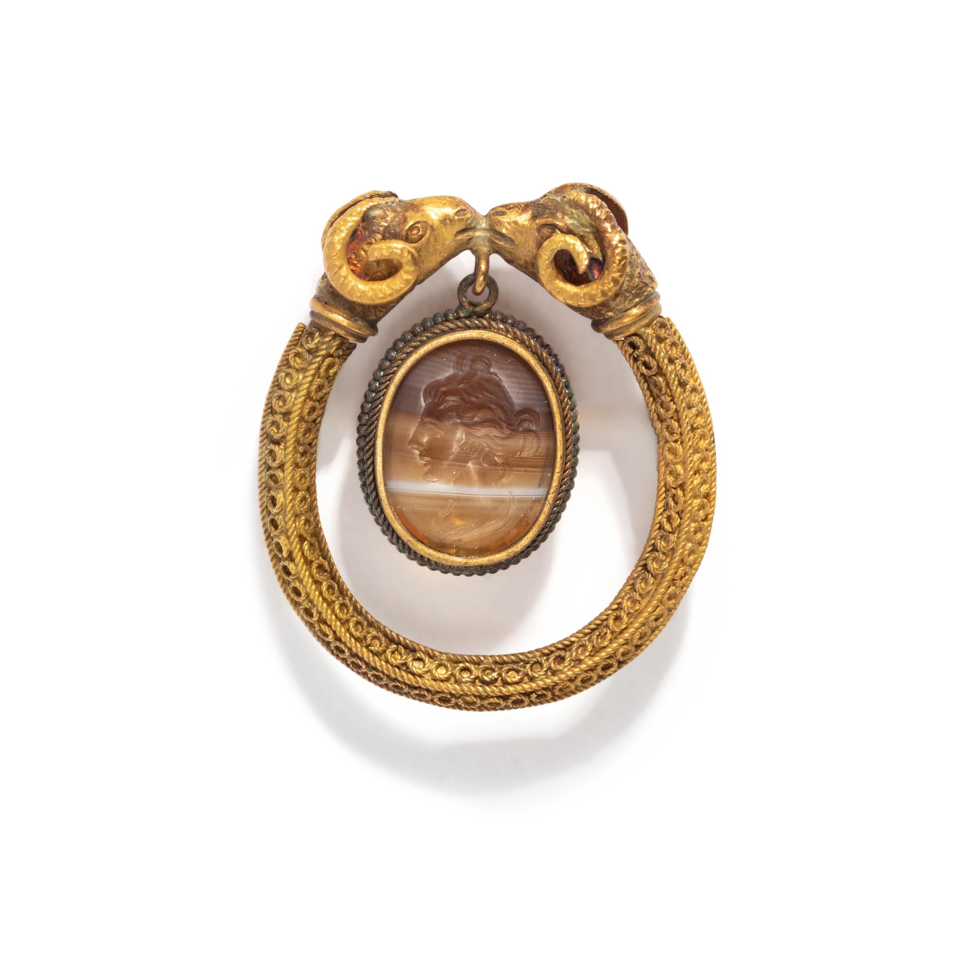 A Roman Banded Agate Intaglio with the God Apollo — Set in a gold brooch with rams