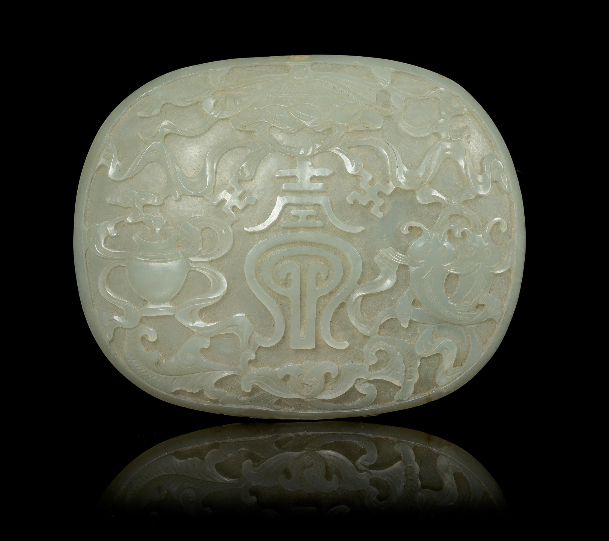 A Celadon Jade Oval Plaque Length 3 3/4 inches. — 19TH CENTURY
