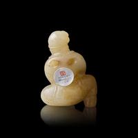 A Chinese Russet and White Jade Carved Foreigner 白玉帶沁胡人