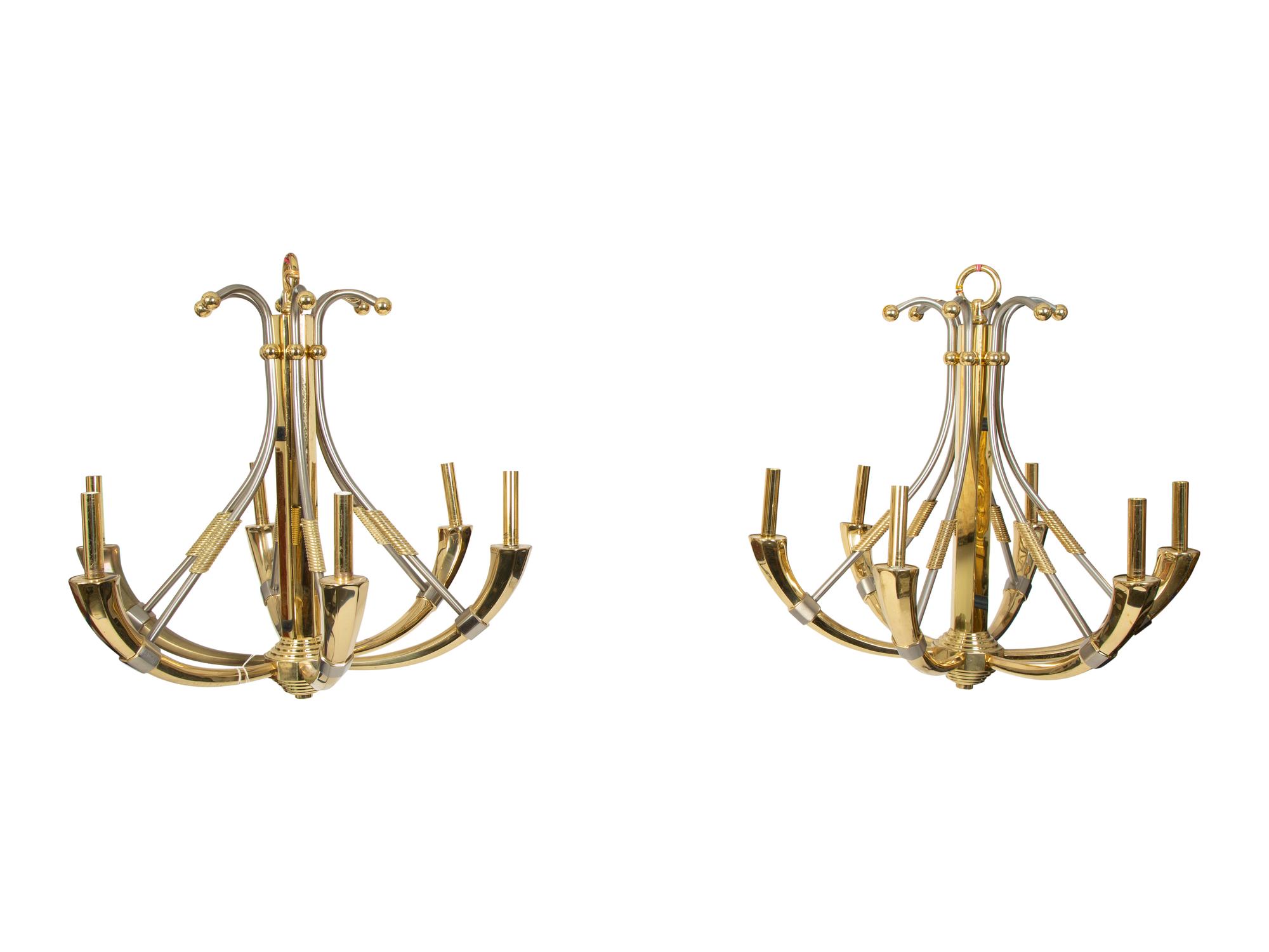 A Pair of Steel and Brass Chandeliers by Maison Jansen