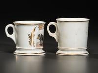 Two Porcelain Shaving Mugs Featuring Horse-Drawn Hearses