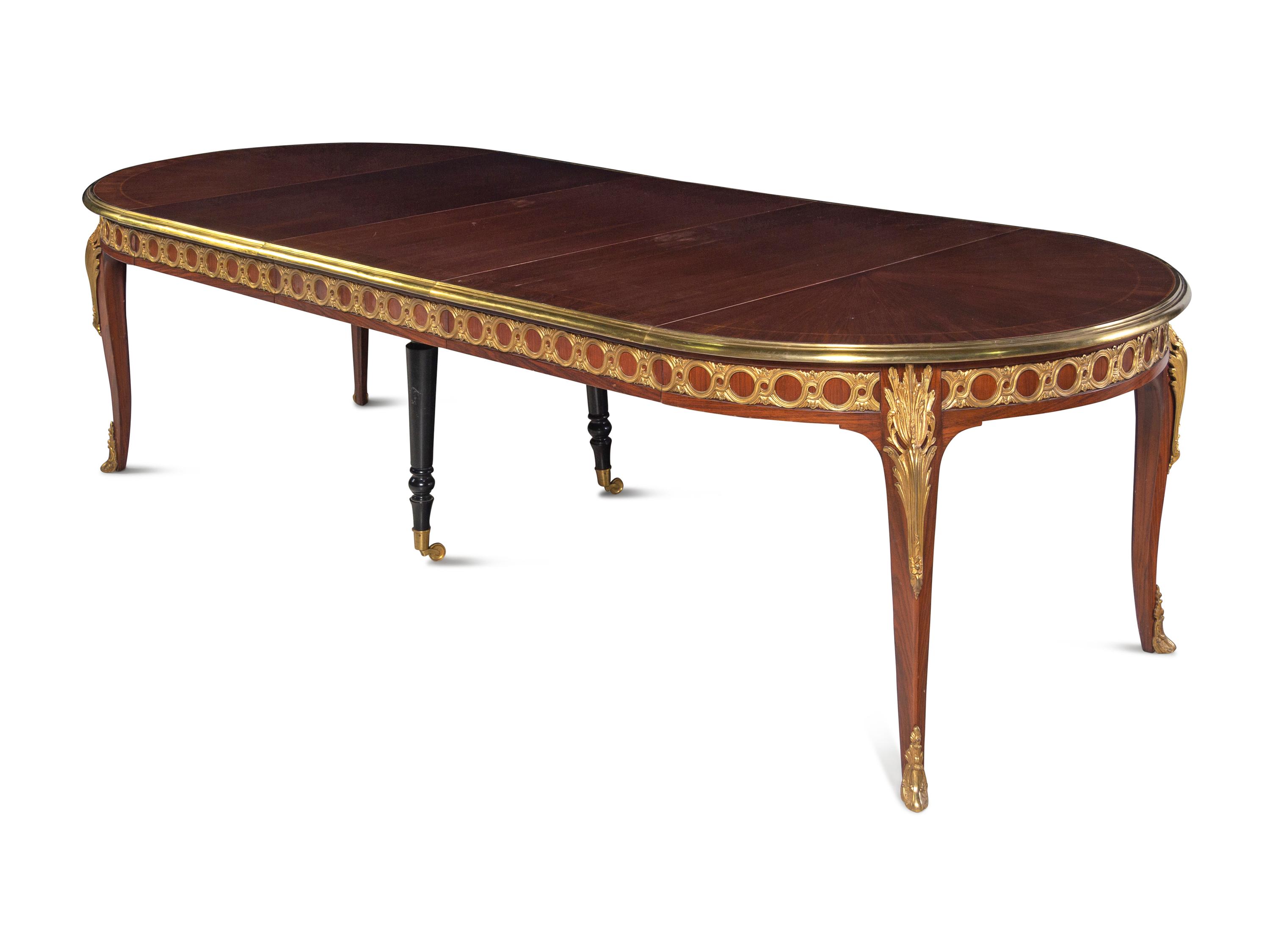 A Louis XVI Style Gilt Bronze Mounted Parquetry Dining Table