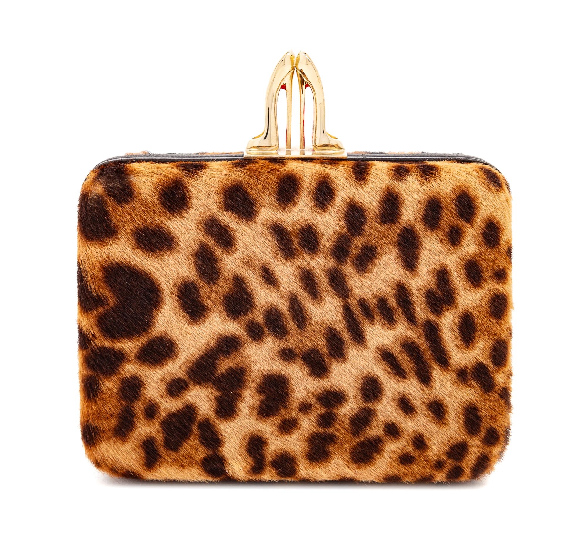 A Christian Louboutin Leopard Print Pony Hair Clutch, 4" H x 5.5" W x 1.5" D.