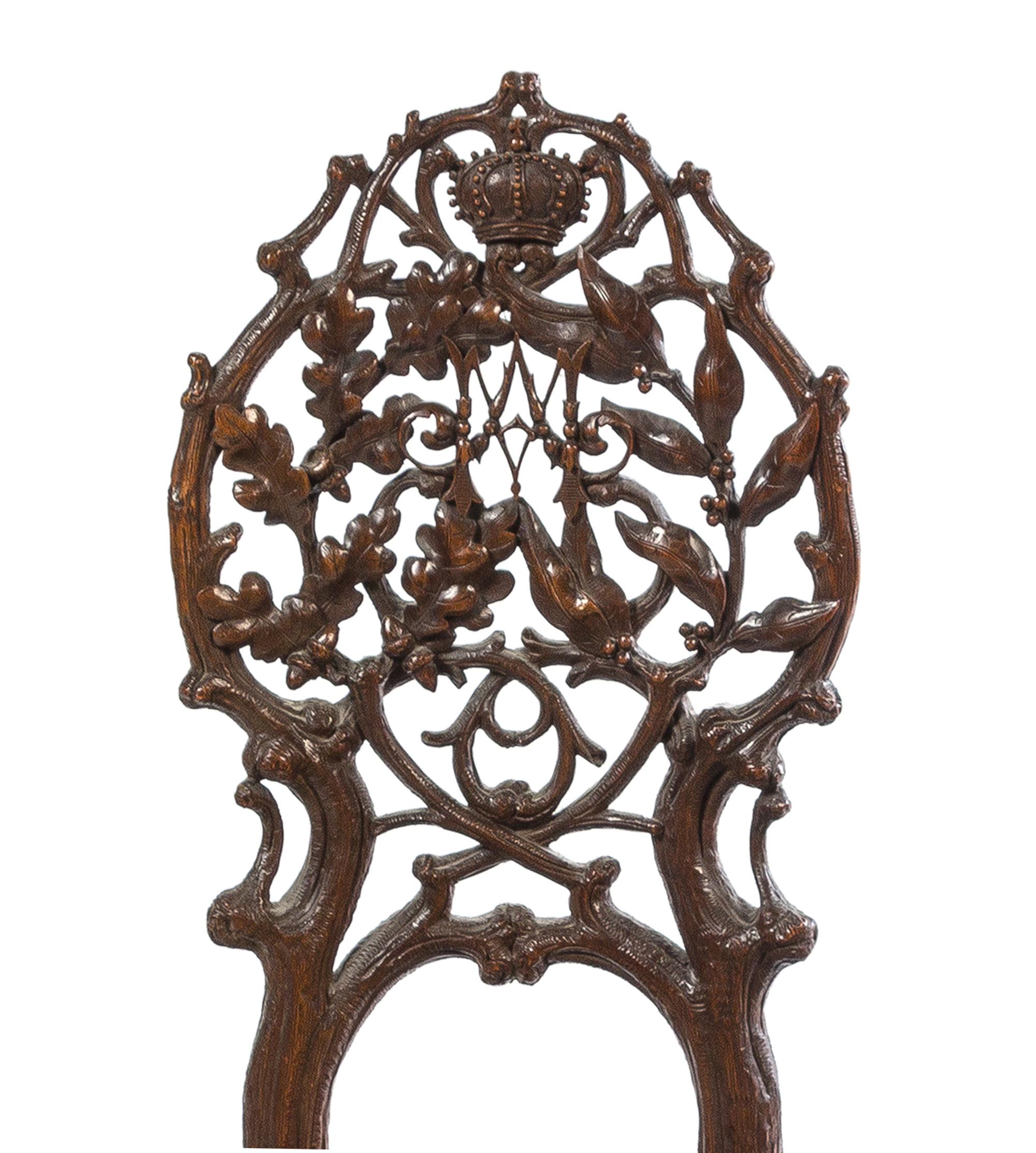 A Pair of Black Forest Pierce Carved Side Chairs Height of tallest 41 1/4 inches. — 19TH CENTURY