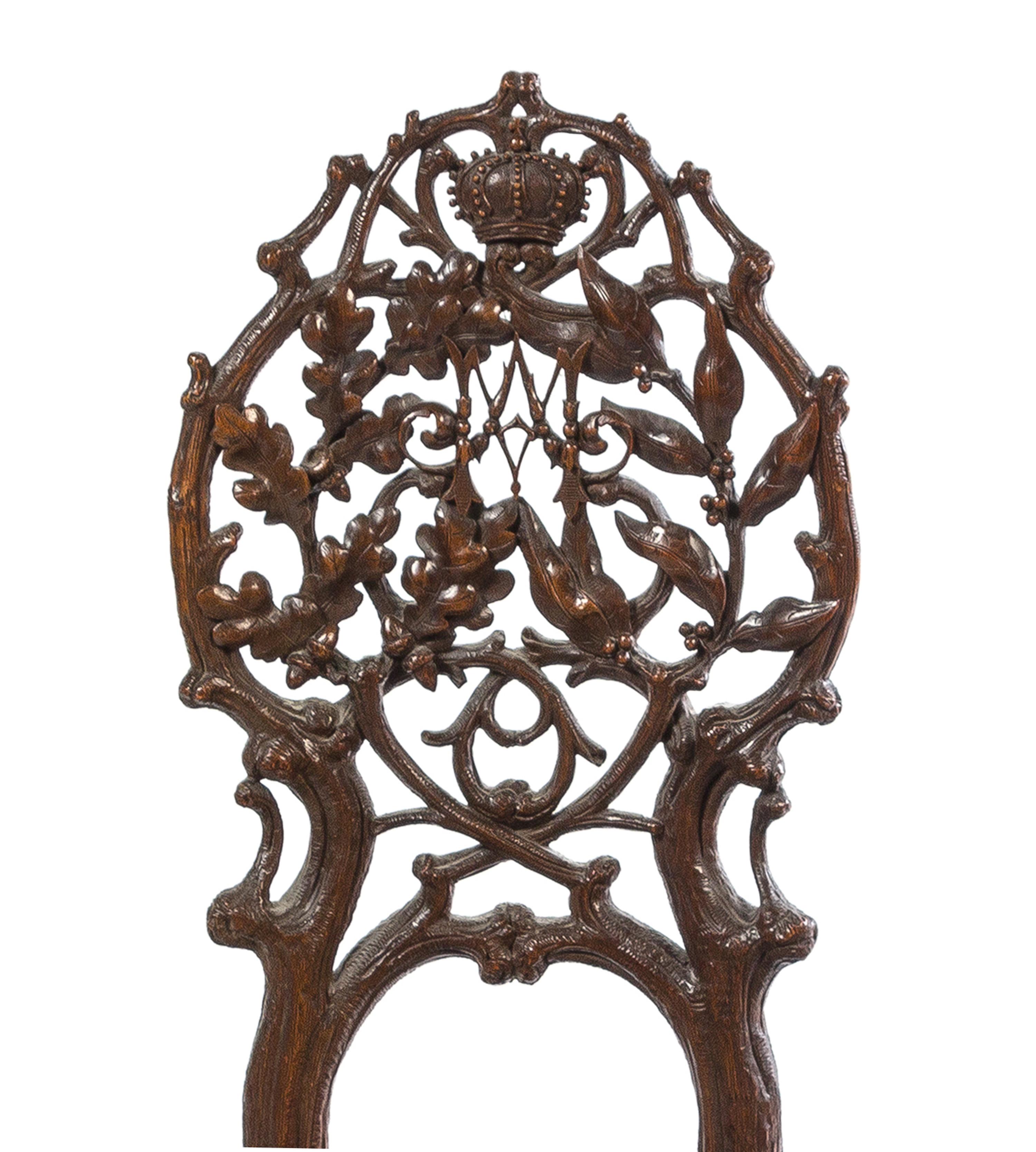 A Pair of Black Forest Pierce Carved Side Chairs Height of tallest 41 1/4 inches. — 19TH CENTURY
