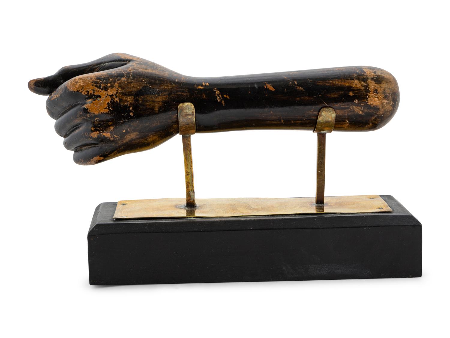 A Carved and Painted Clinched Fist