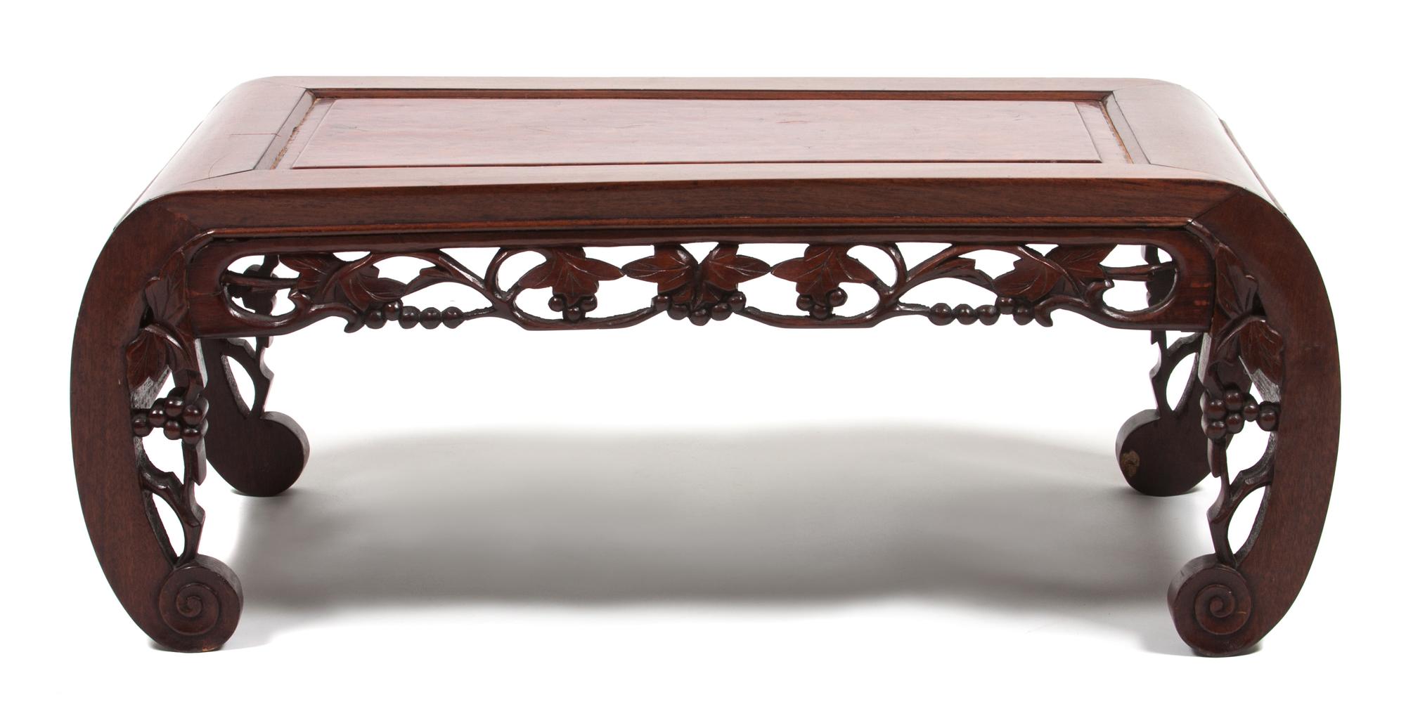 A Chinese Carved Hardwood Low Table Height 10 1/2 x width 29 x depth 14 3/4 inches.