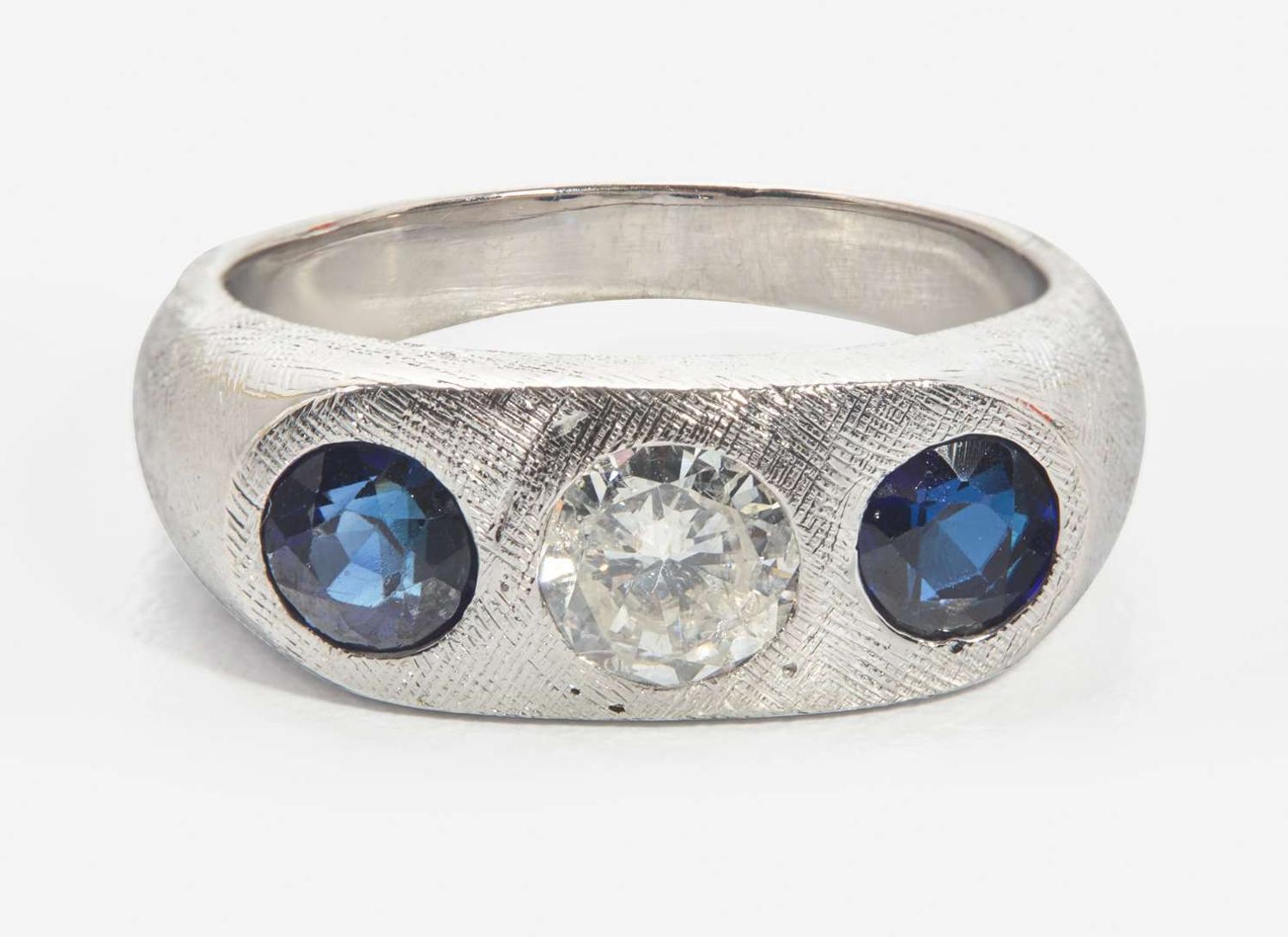 An 18K White Gold, Sapphire, and Diamond Three-Stone Ring