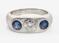 An 18K White Gold, Sapphire, and Diamond Three-Stone Ring