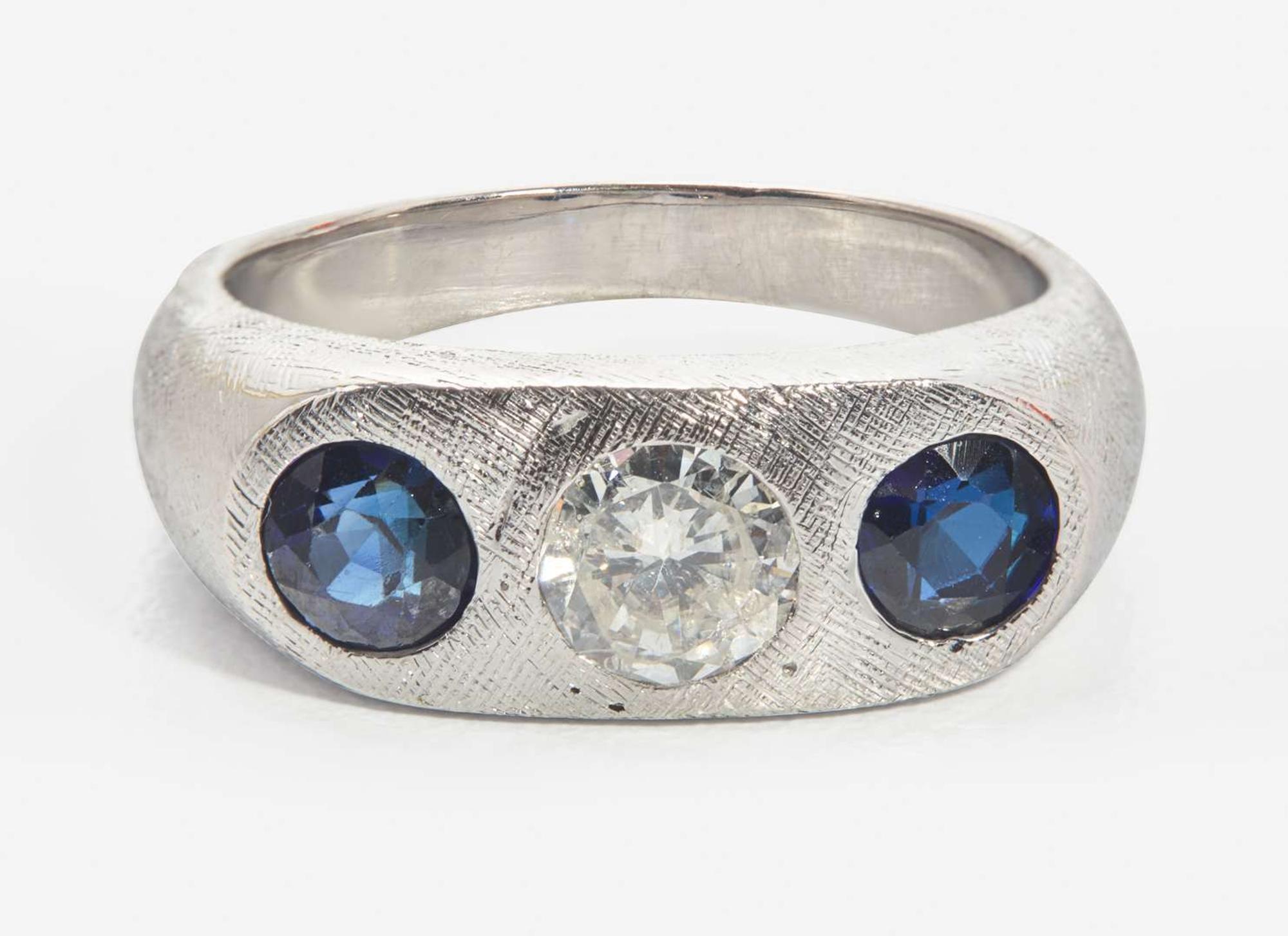 An 18K White Gold, Sapphire, and Diamond Three-Stone Ring