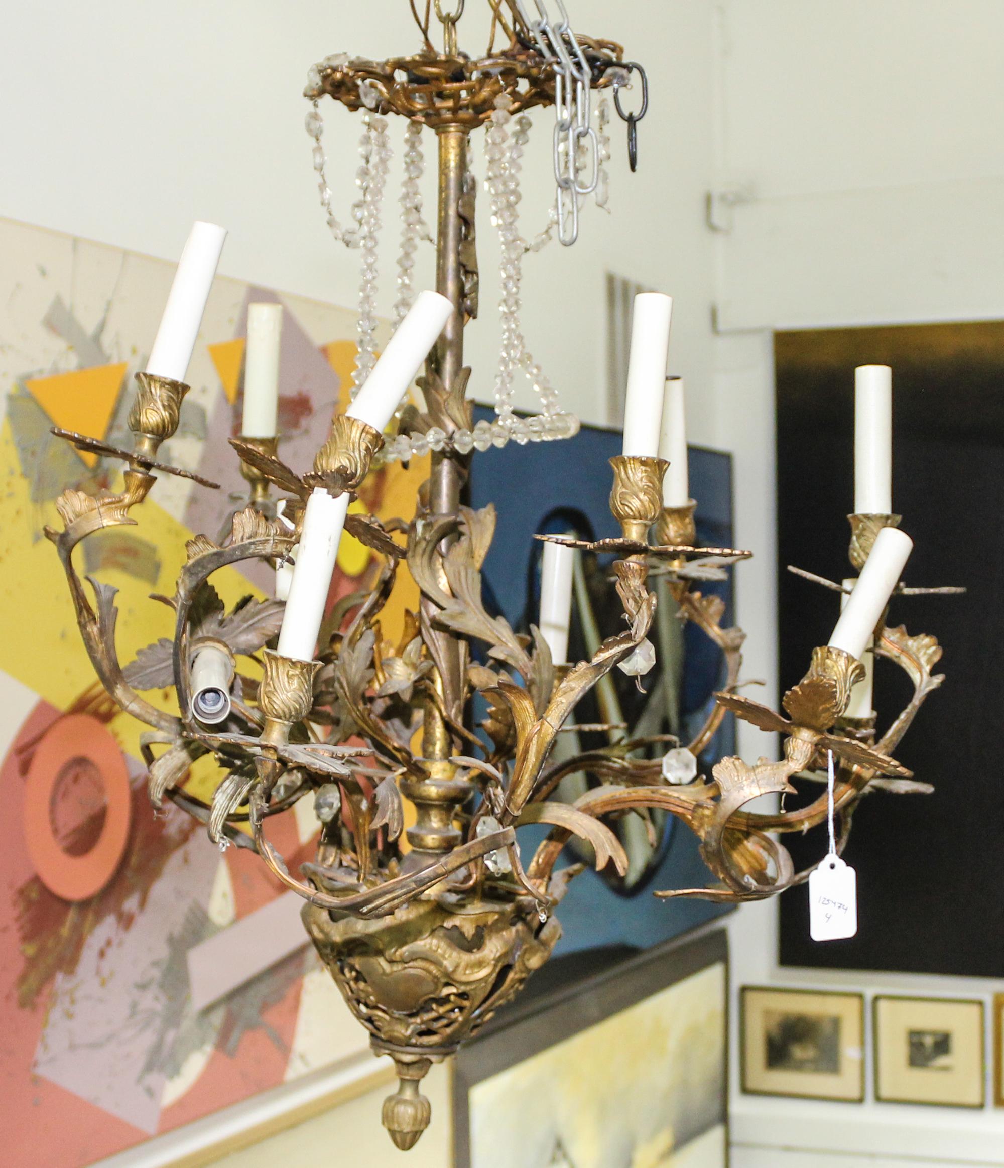A Cast Metal Eight-Light Chandelier Height 26 inches.
