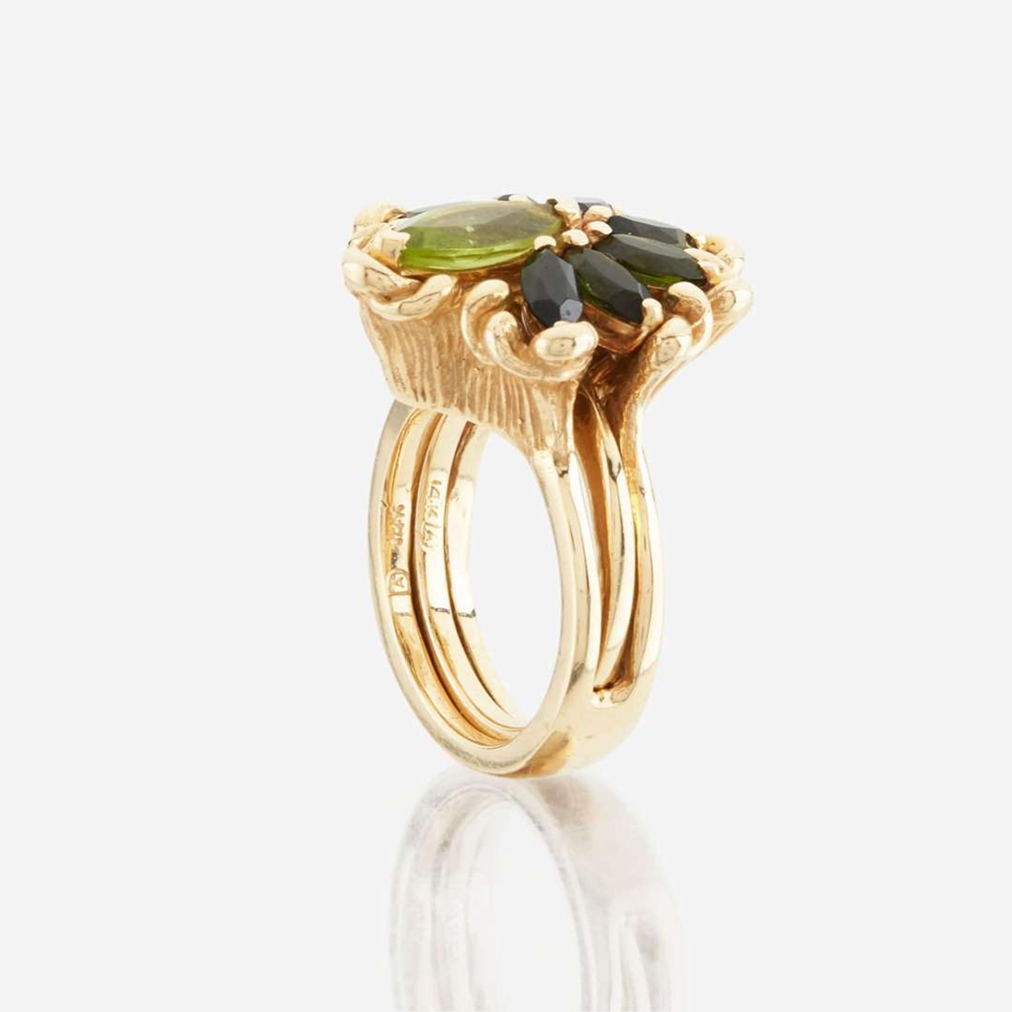 A peridot, green tourmaline, and gold ring