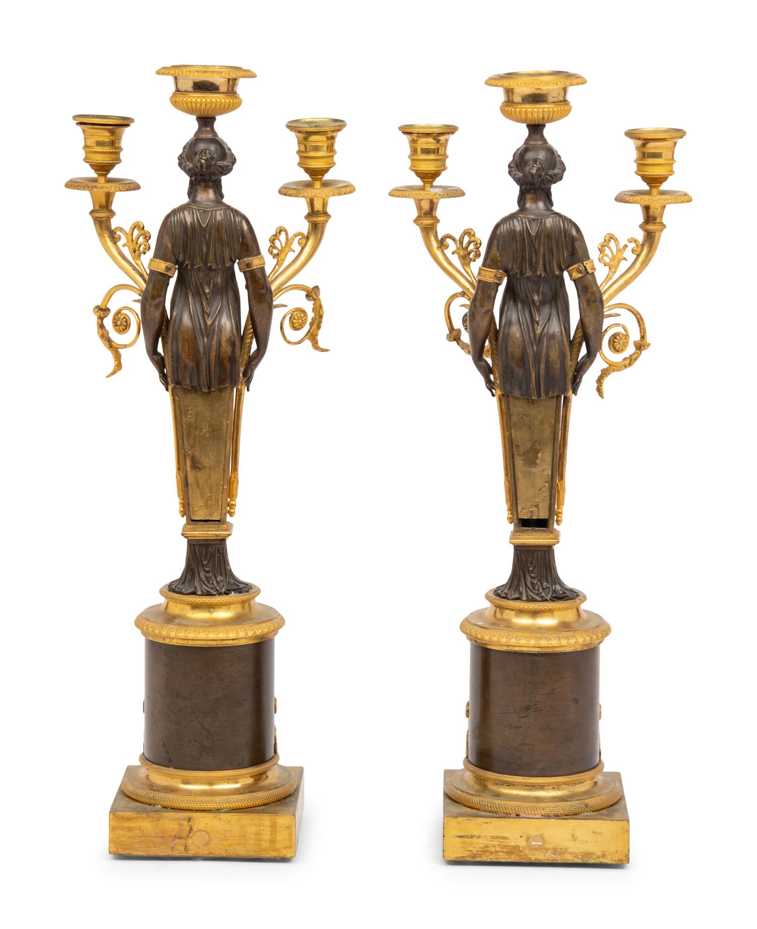 A Pair of Restauration Ormolu and Patinated Bronze Figural Three-Light Candelabra