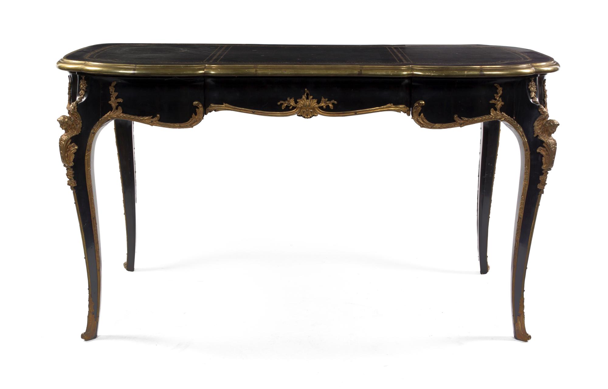 A Napoleon III Ebonized and Gilt Metal Mounted Bureau Plat, Height 29 x width 54 1/2 x depth 29 inches.