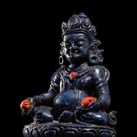 A Sino-Tibetan Carved Lapis Lazuli Figure of Jambhalā
