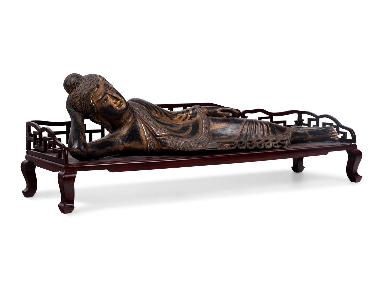 A Thai Gilt Decorated Black Lacquered Wood Figure of Reclining Buddha