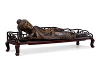 A Thai Gilt Decorated Black Lacquered Wood Figure of Reclining Buddha
