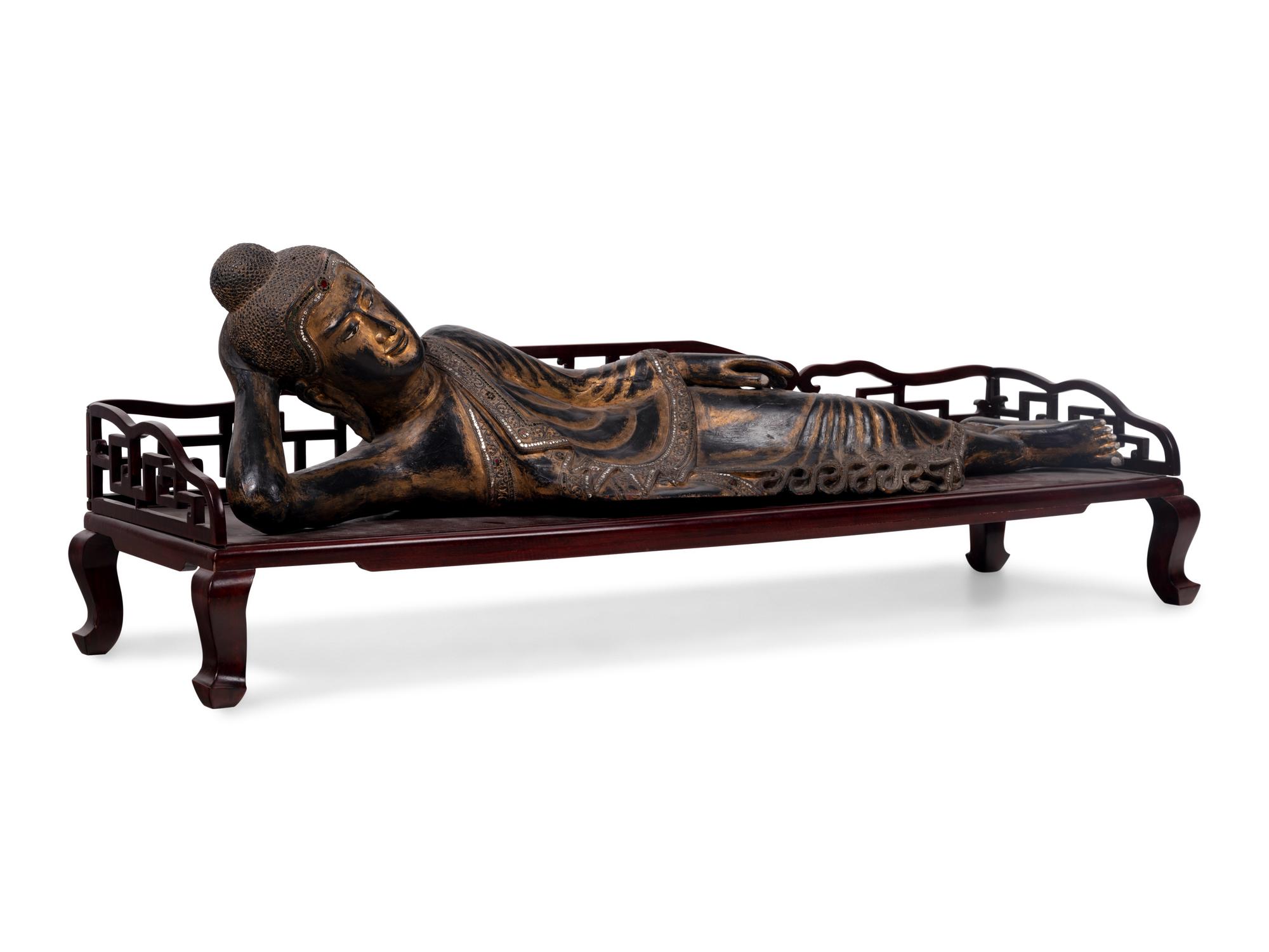 A Thai Gilt Decorated Black Lacquered Wood Figure of Reclining Buddha