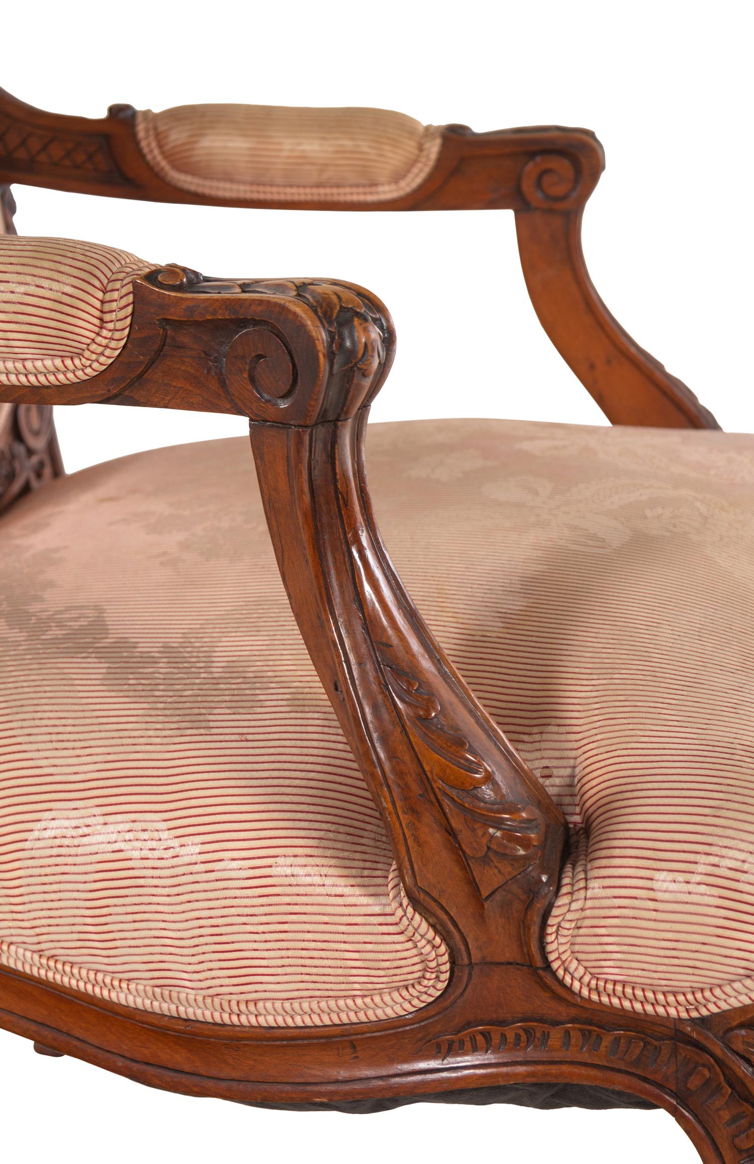 A Louis XV Style Carved Walnut Fauteuil