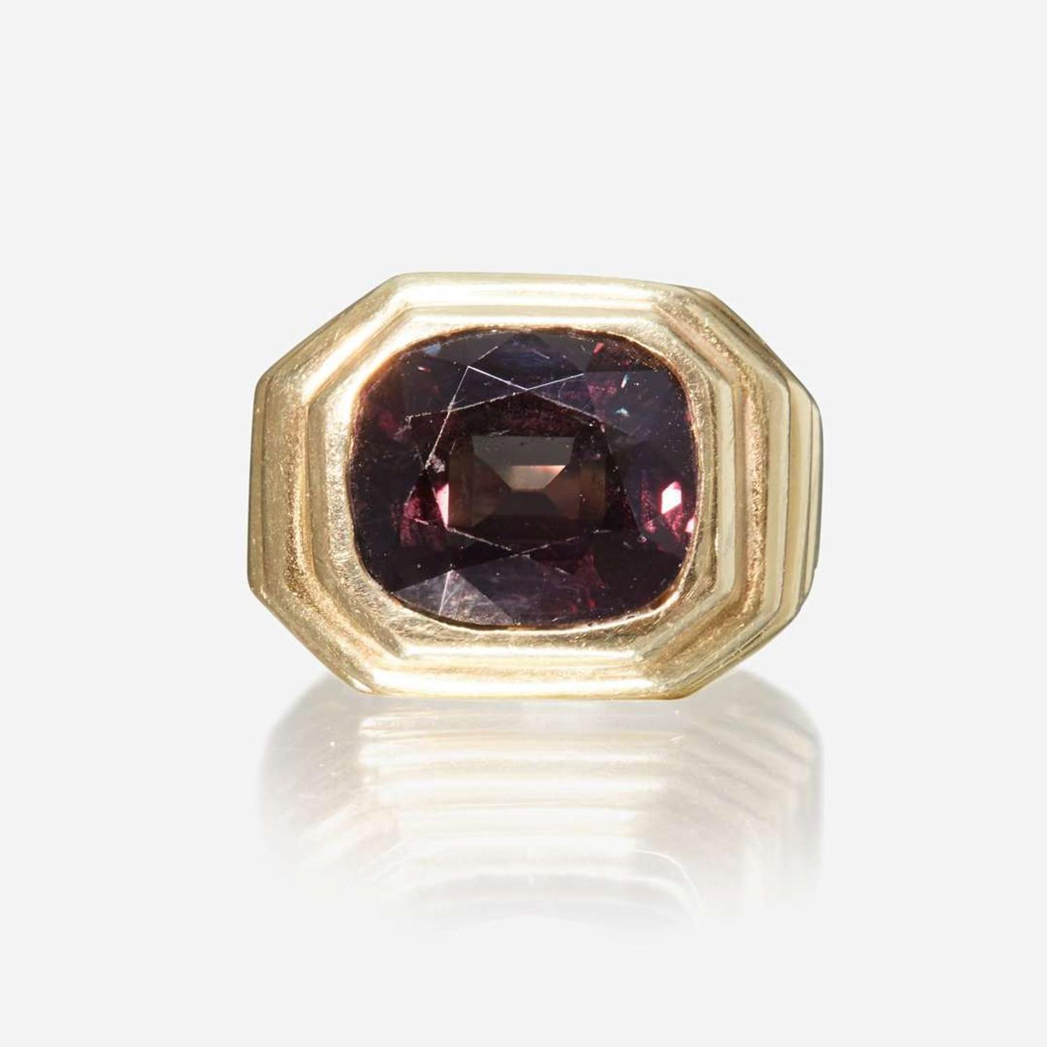 A color change alexandrite and eighteen karat gold ring